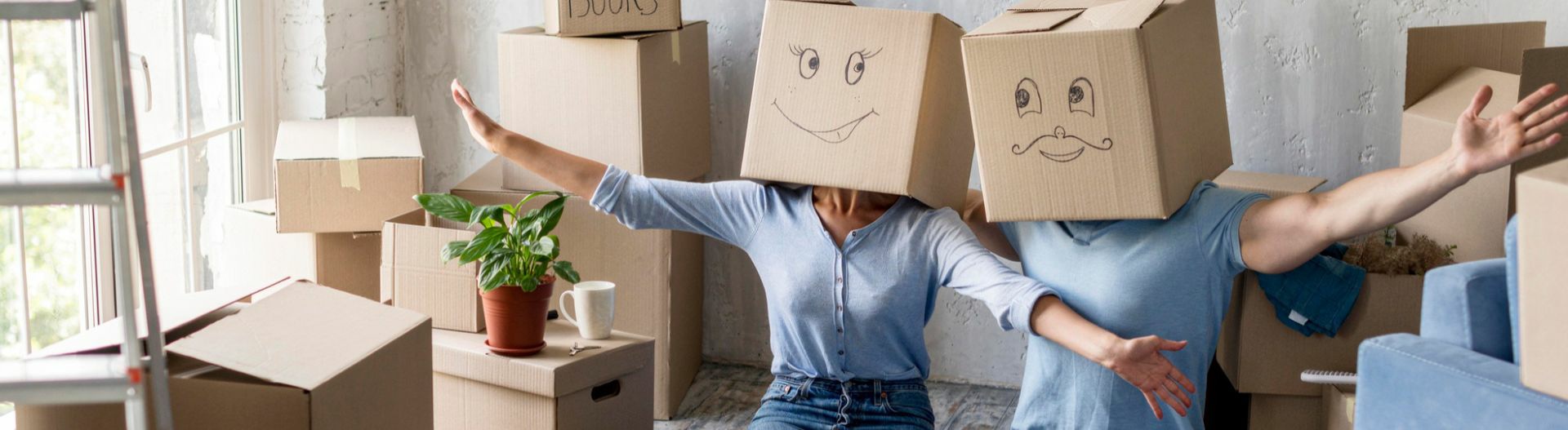 Image of two people with smiley face boxes on their heads