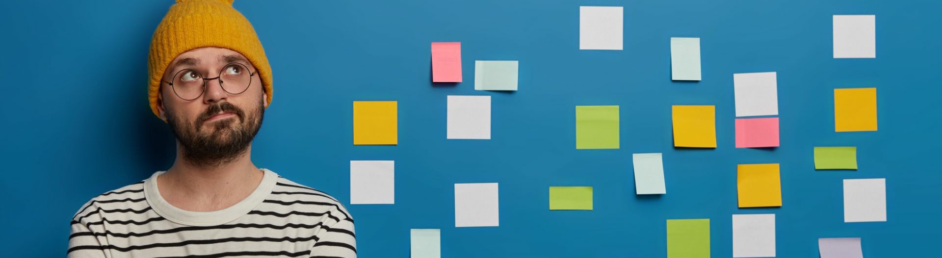 Image of a man and post it notes on a wall